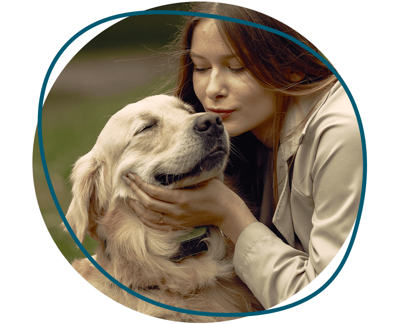 woman kissing golden retriever dog